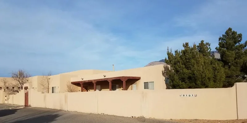Exterior view of the rehab facility behind a fence.