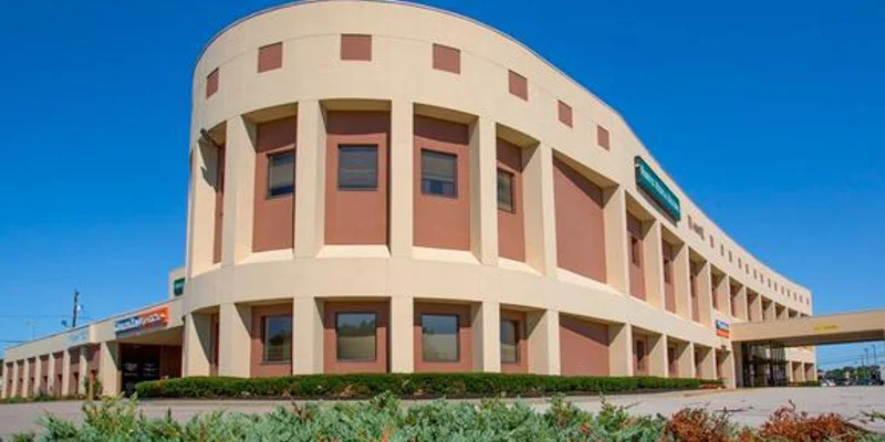 Facility exterior with large windows and signage.