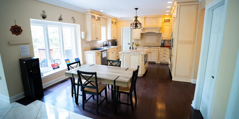 Large kitchen with wood cabinets and small dining table