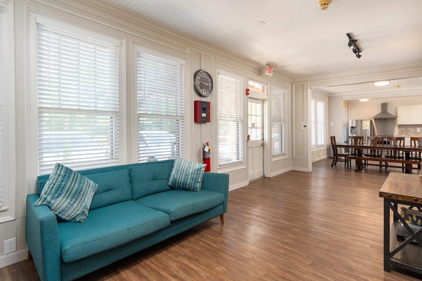 Lounge with a sofa and table next to entrance.
