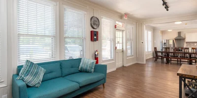 Lounge with a sofa and table next to entrance.