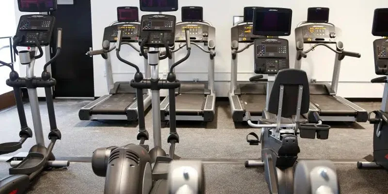 Gym with treadmills, ellipticals, and other exercise equipment.