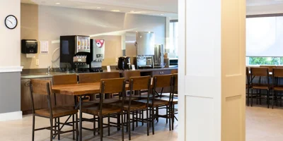 Cafeteria area with shared long tables and seating.