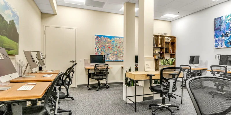 Workspace with multiple computer stations and chairs.