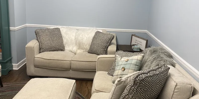 Cozy therapy room with beige sofas and decorative pillows