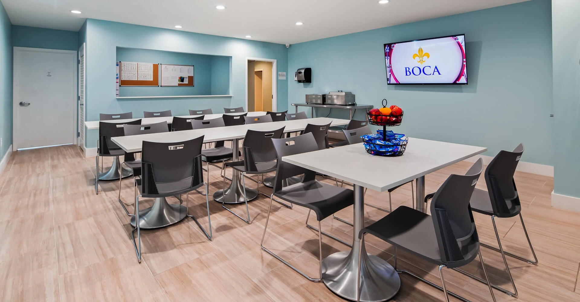Dining area with tables, snacks, and a TV.