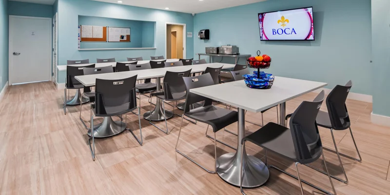Dining area with tables, snacks, and a TV.