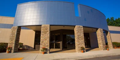 A building with stone columns at the entrance walkway.