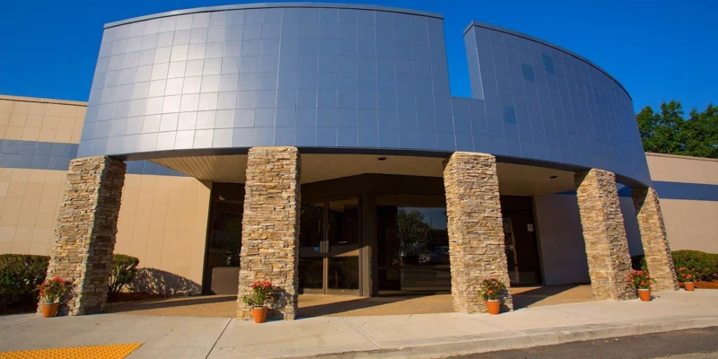 A building with stone columns at the entrance walkway.