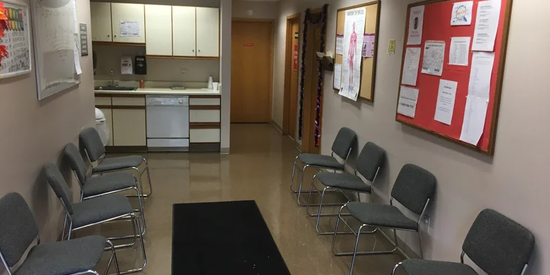 Waiting area with chairs along the wall.