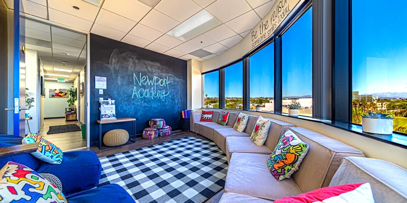 Lounge with seating and chalkboard wall.