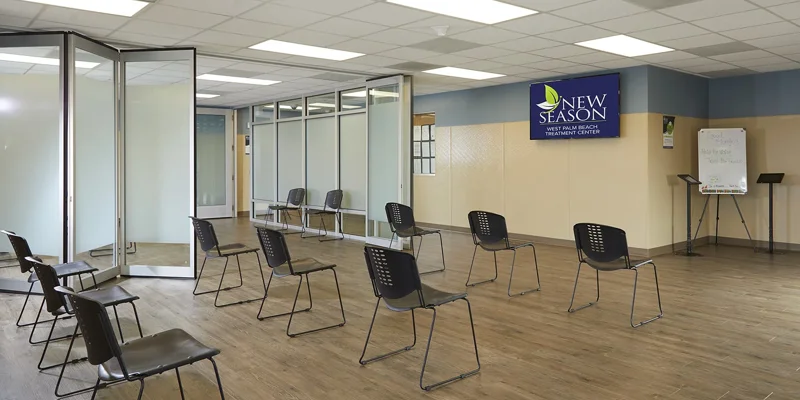 Group therapy room with chairs and a TV.