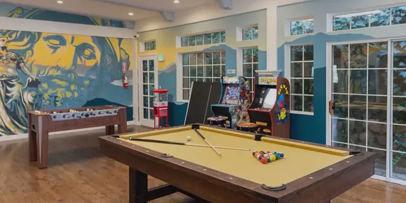 Game room with a pool table and foosball table.