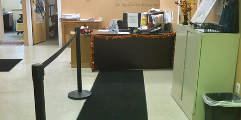 Waiting area leading to reception desk and offices.