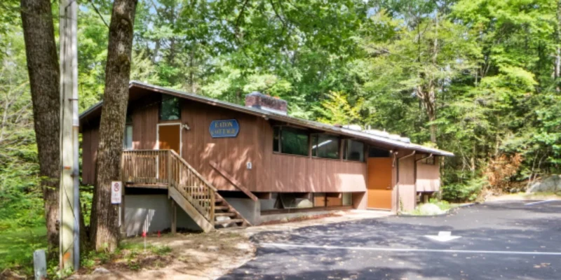 Building with trees and a paved driveway.