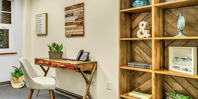 Office space with a desk, chair, and bookshelf.