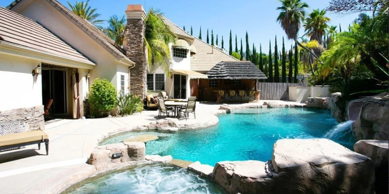 Backyard pool with seating.