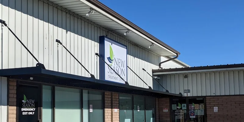 Exterior of New Season Treatment Center with signage and glass windows.