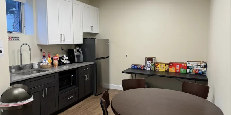 Break room with kitchenette and snack table