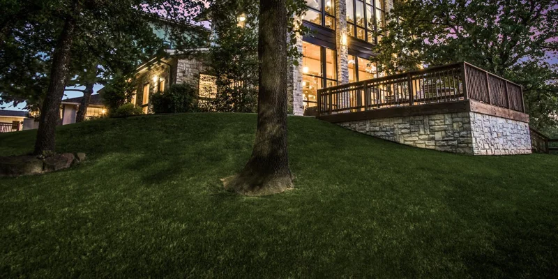 Rehab facility at night, surrounded by trees and soft lighting
