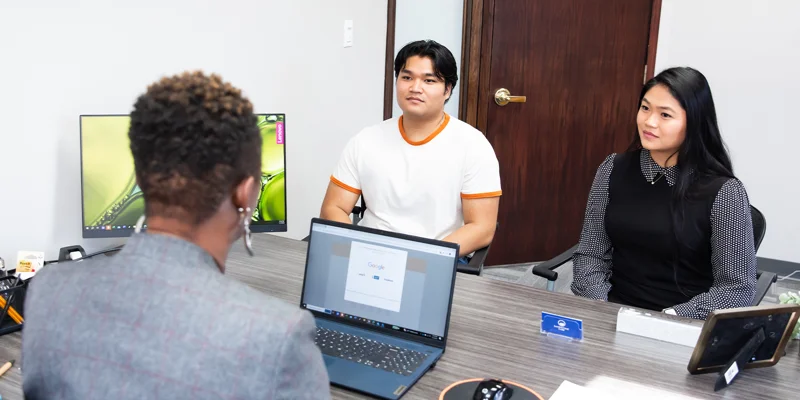 Office space with people at the table.