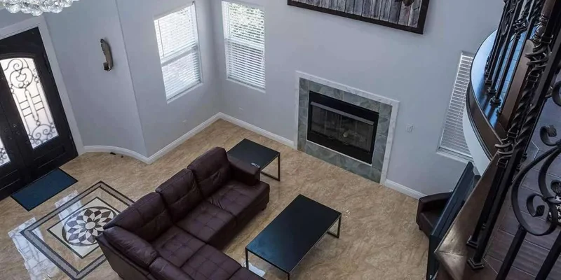 Living room with a sofa, and a fireplace.