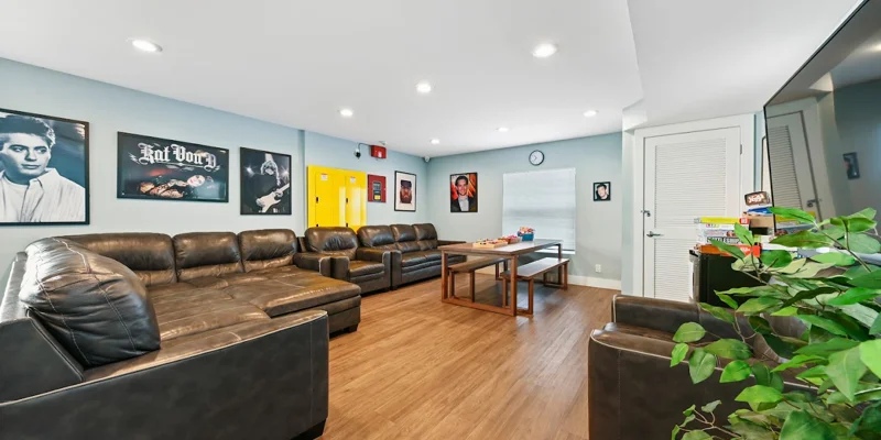 Lounge with seating, artwork, and a game table.