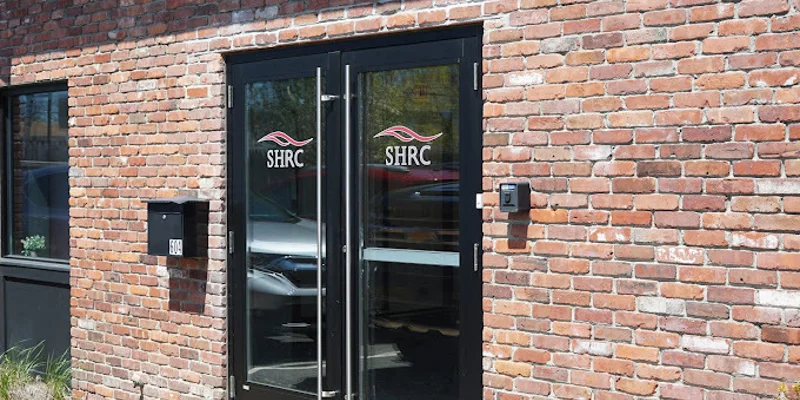 Red-brick exterior with entrance walkway.