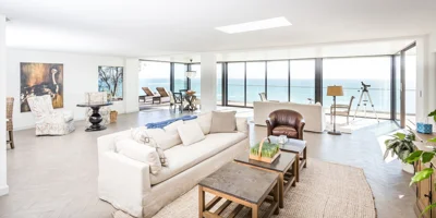 Living area with couches and large windows.