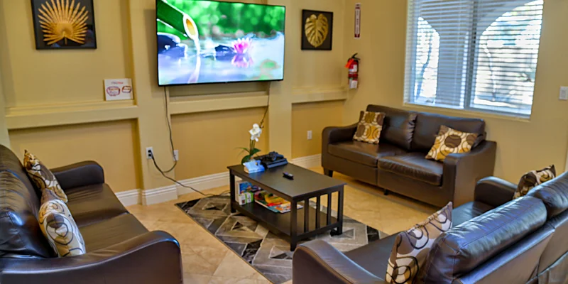 Living room with sofas, a TV, and a coffee table.