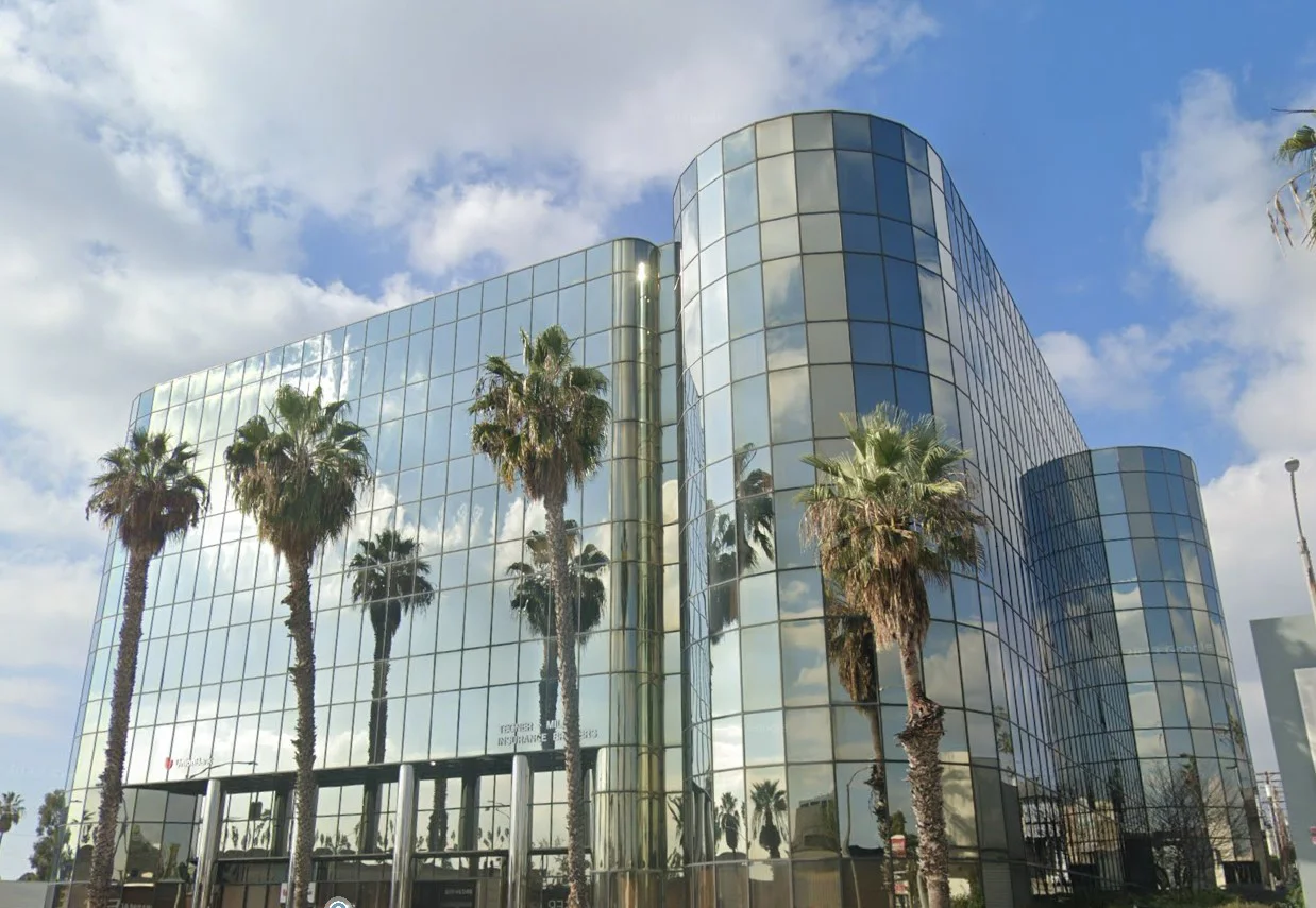 Facility building view with trees.