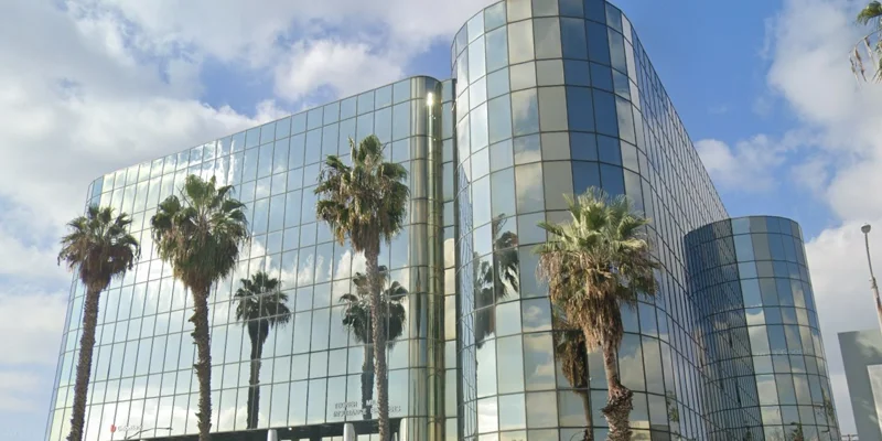 Facility building view with trees.