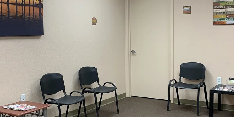 Waiting area with chairs and tables.