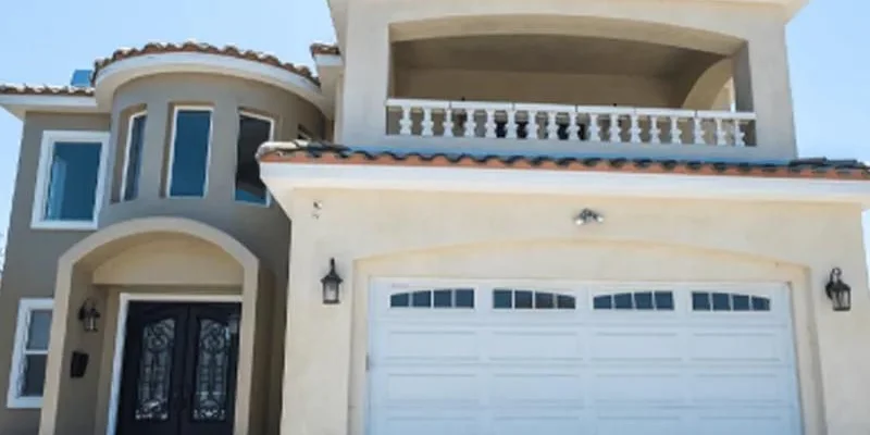 Facility exterior with a balcony, garage and entrance.