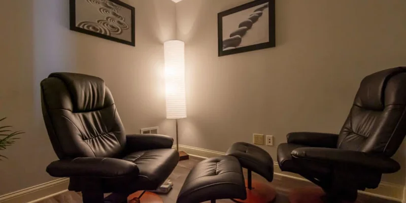 Therapy room with reclining chairs and soft lighting.