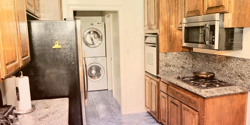 Kitchen with wooden cabinets and stainless steel appliances.
