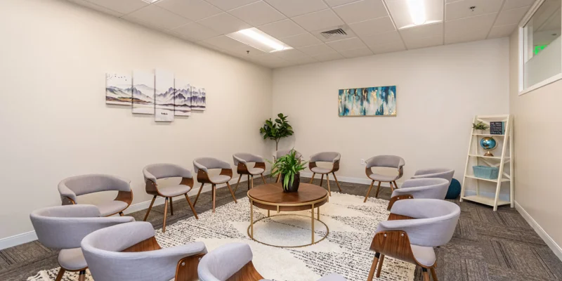 Group therapy room with chairs arranged in a circle.