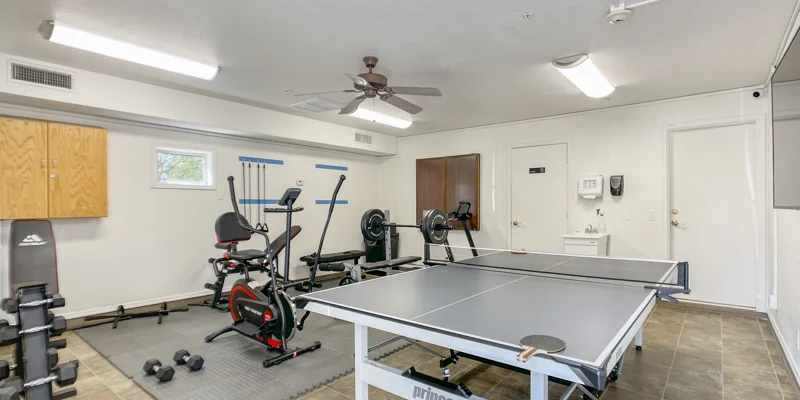 Recreational room with gym equipment, a ping-pong table.