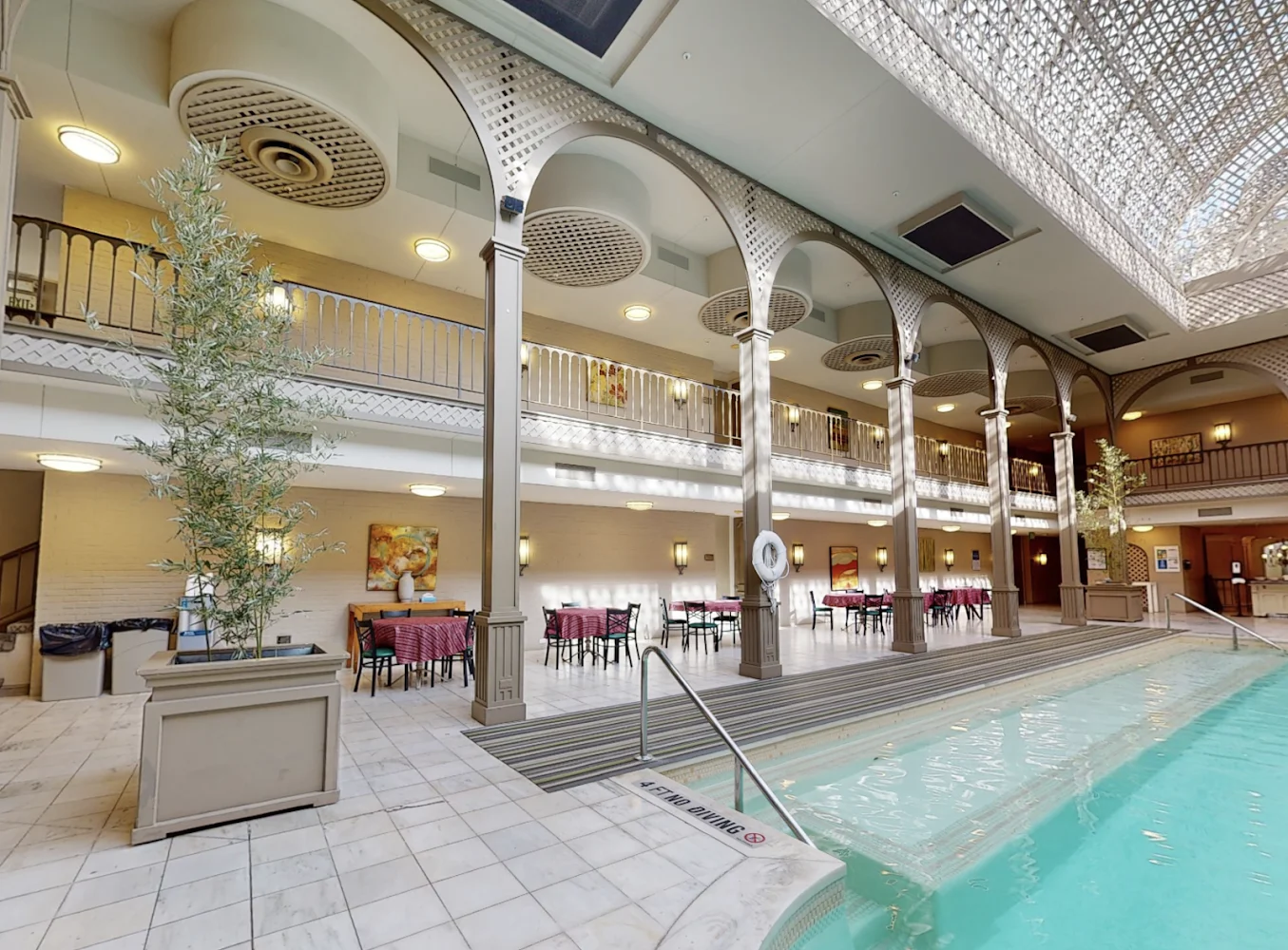 Indoor rehab facility with a pool and dining area.