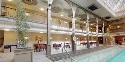 Indoor rehab facility with a pool and dining area.