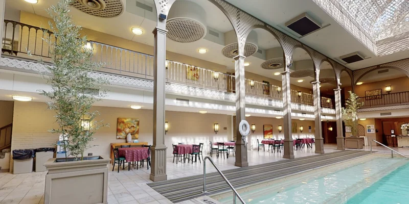 Indoor rehab facility with a pool and dining area.