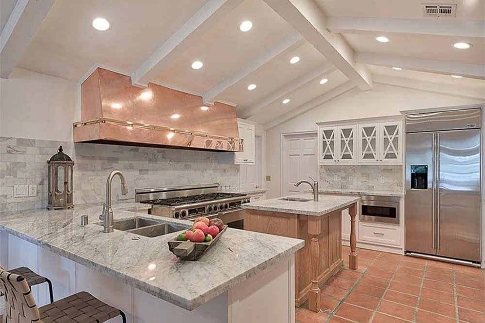 Kitchen with a central island and seating.