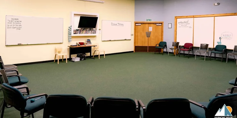 A spacious group therapy room with chairs arranged in a circle