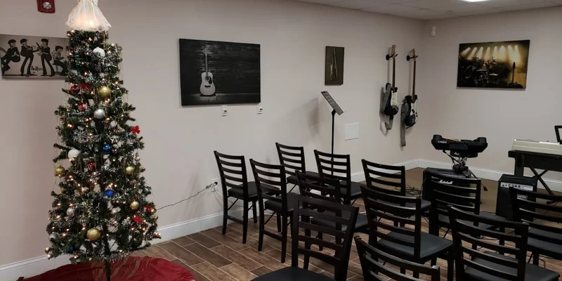 Music room with instruments and seating.