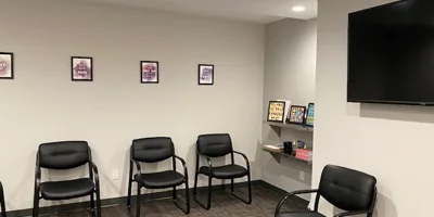 Spacious group therapy room with chairs set in a circle.