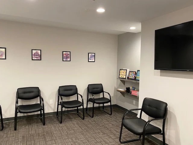 Spacious group therapy room with chairs set in a circle.