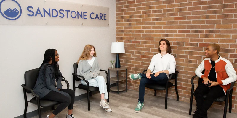Waiting area with chairs, and a Sandstone Care sign.