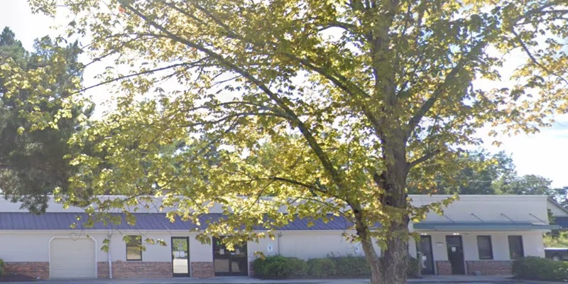 Facility exterior with entrance and parking.