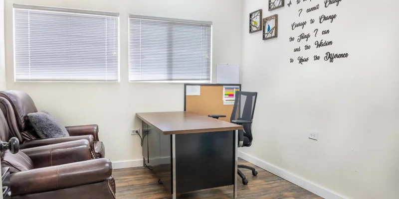 Small office with a desk, chair, and laptop
