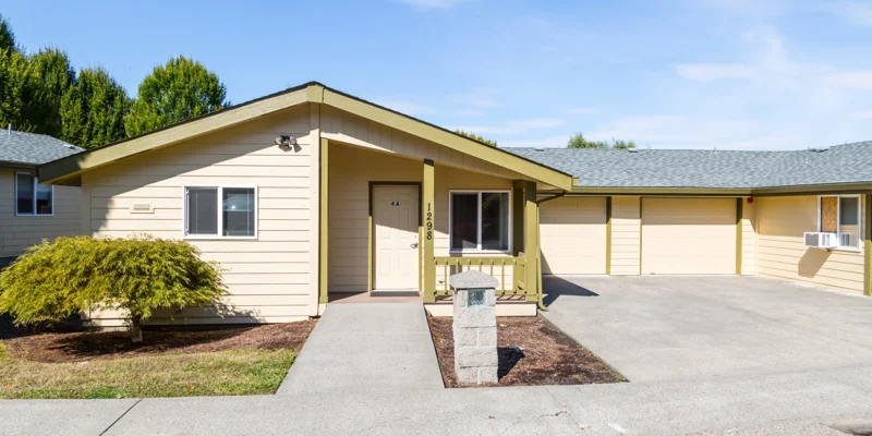 The exterior of a yellow single-story residential rehab facility.